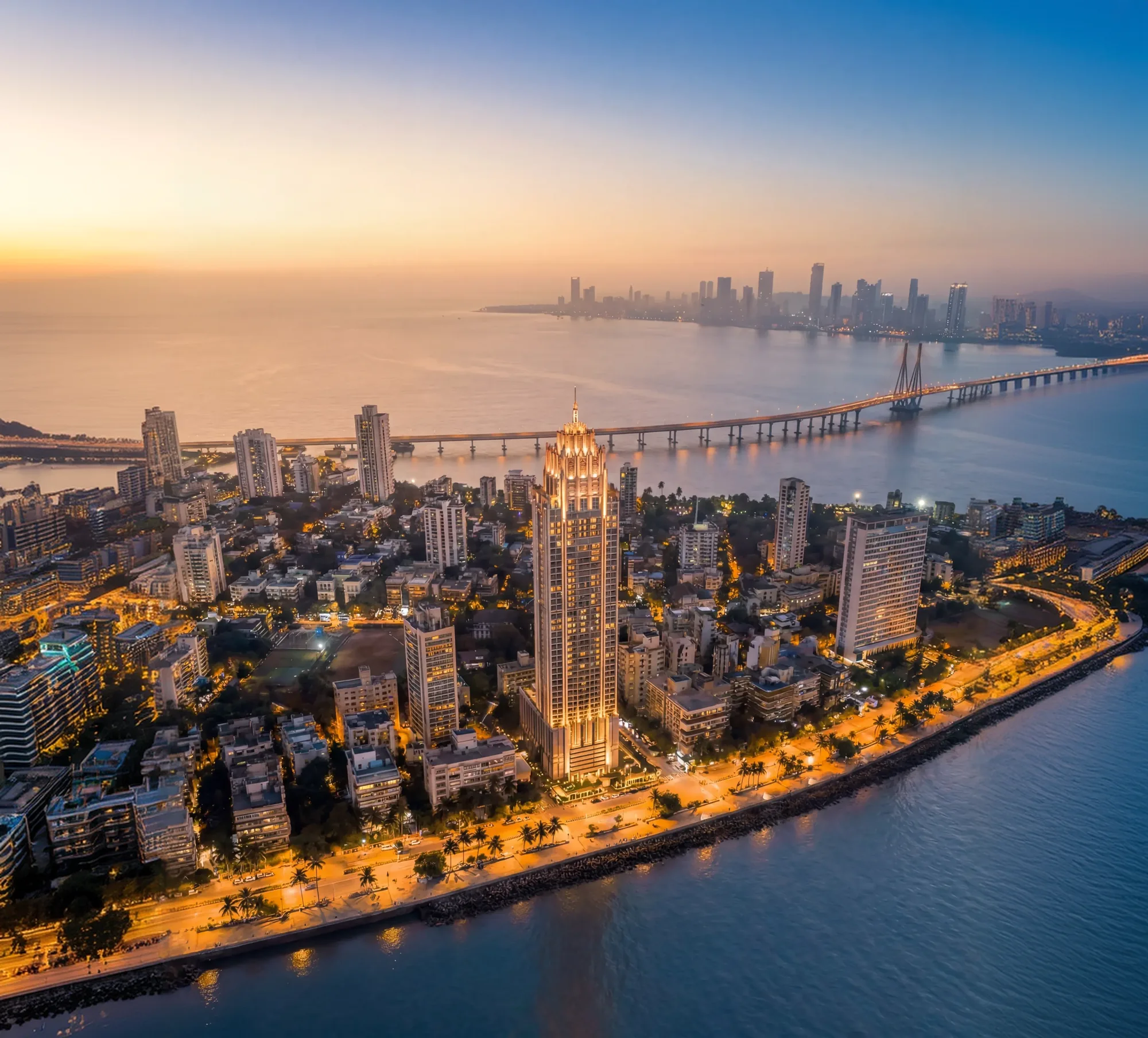 Lotus Aquaria: the Prabhadevi seafront at dusk, the tower lit against the Bandra-Worli Sea Link.